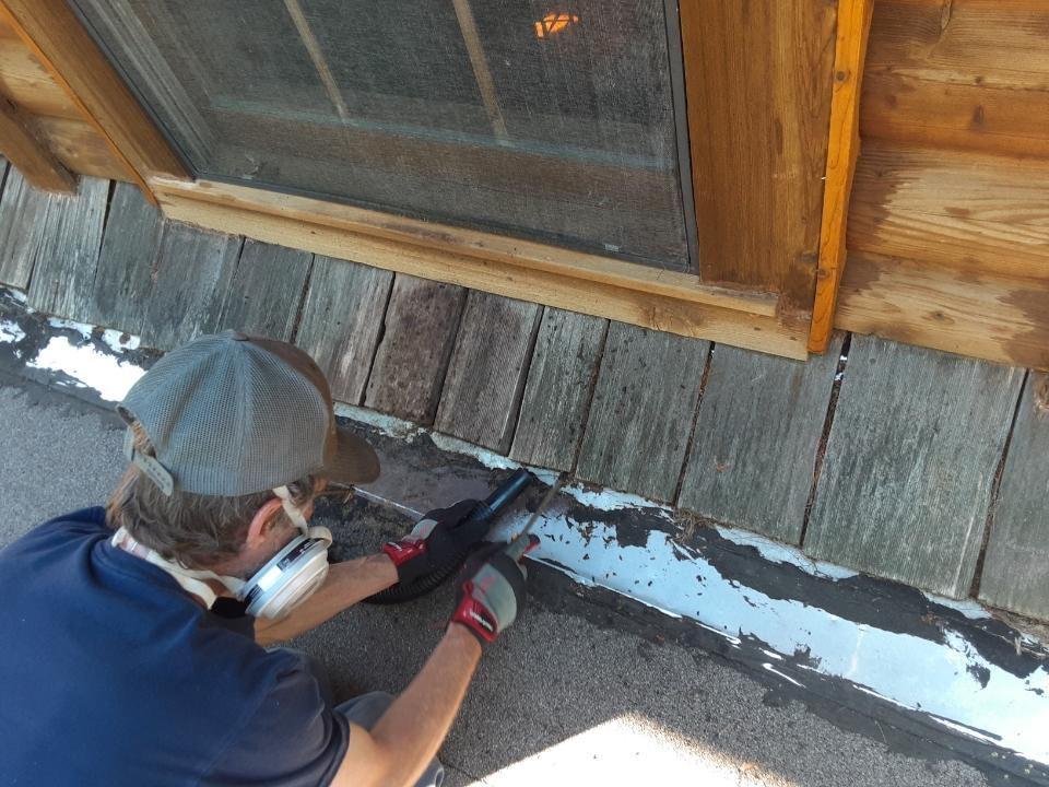 michiana wildlife team sealing window trim on wooden exterior